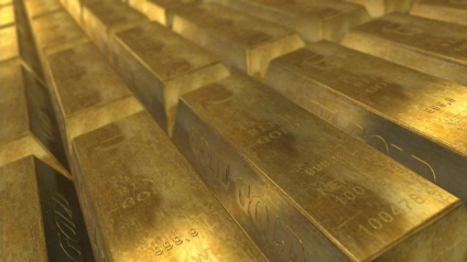 Gold bars stacked, labeled with weight and purity (fine gold 999.9), representing physical gold assets commonly used in Gold IRA investments.