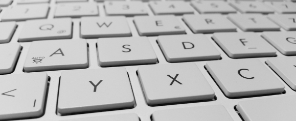 Close up of a white computer keyboard, highlighting everyday device use and online activity. The image represents antivirus protection like AVG working in the background to keep your computer and keyboard safe from digital threats.