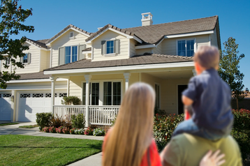 Homeowners looking at remodeled home with DaBella windows