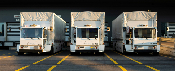 Row of commercial trucks parked at a loading dock, illustrating Samsara fleet tracking technology.