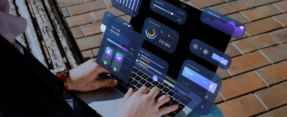 Person working on a laptop outdoors with floating digital dashboards showing graphs, transactions, task progress, and data visualizations. The image represents using CRM software like Pipedrive to manage tasks, monitor performance, and track financial metrics in real-time.