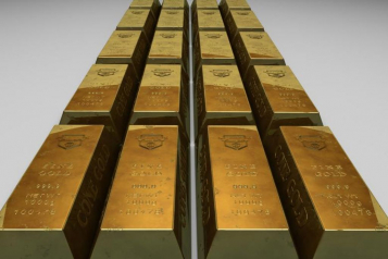 Gold bars stacked on a clean surface, labeled with weight and purity (fine gold 999.9), representing physical gold assets commonly used in Gold IRA investments.