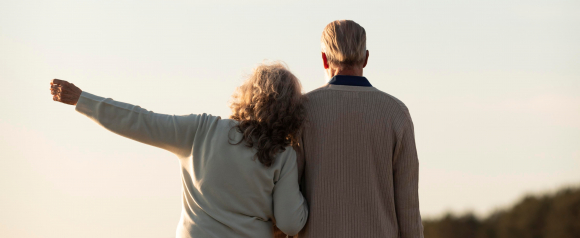 Senior couple walking closely together, symbolizing trust and independence supported by medical alert systems like Life Assure.