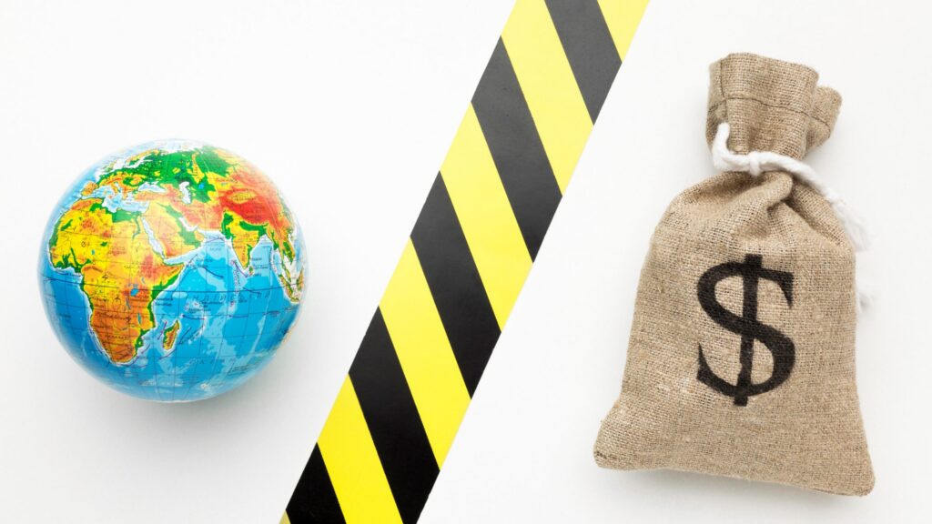 A globe and a money bag with a dollar sign separated by yellow and black hazard tape, symbolizing international economic sanctions and global financial restrictions.
