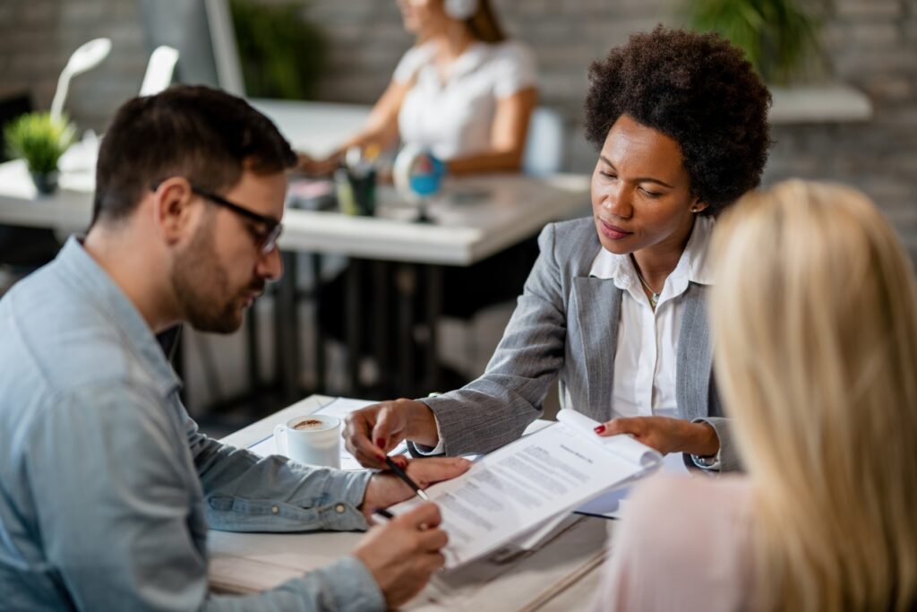 Tax professional explaining an IRS Fresh Start installment agreement to a couple reviewing documents