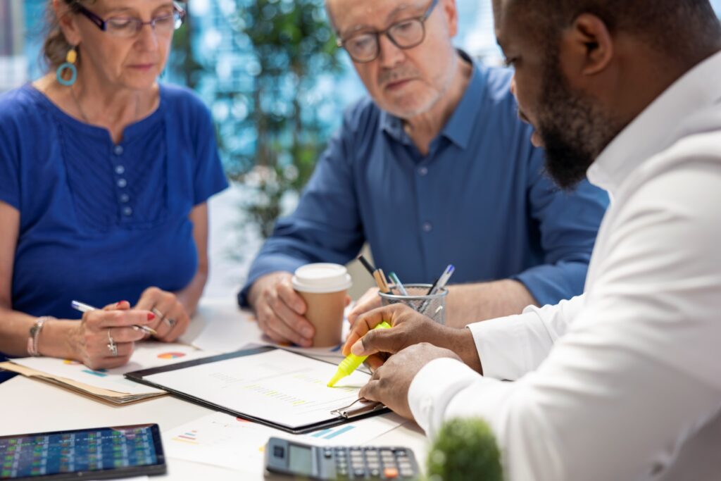 Tax relief consultant reviewing IRS Fresh Start program options with a couple at a desk