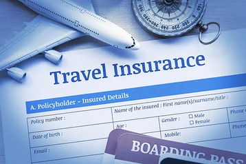 Travel insurance policy form next to a toy airplane, a compass, and a boarding pass