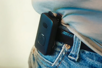 Consumer Cellular IRIS Ally medical alert device clipped to a waistband