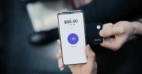 Stripe Terminal Tap to Pay on a smartphone showing a $95.Stripe Terminal Tap to Pay on a smartphone showing a $95.00 total as a customer holds a contactless card to the screen